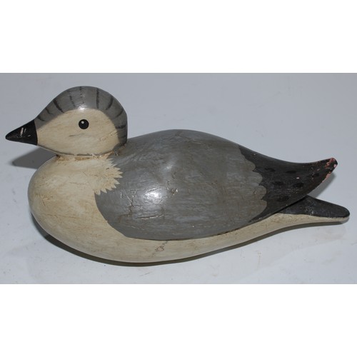 5091 - A carved softwood decoy, as a water bird, 25cm long; another (2)