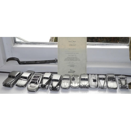 128 - Danbury Mint pewter replica cars. 1955 MKVII, 1986 XJ6, 1992 XJ220, 1935 SSI salon;   others (13)