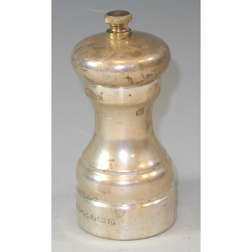 281 - A silver pepper grinder of traditional slender waisted cylindrical form, 10cm high