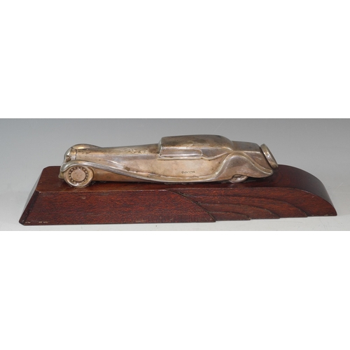 287 - Automobilia - A silver library or desk model of a classic car, styalised, art deco style hardwood st... 