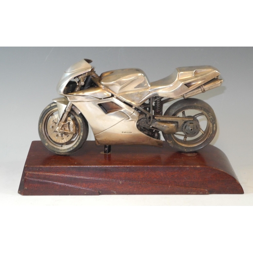 290 - Automobilia - A silver library or desk model of a Ducati motorbike, art deco style hardwood stand, t... 