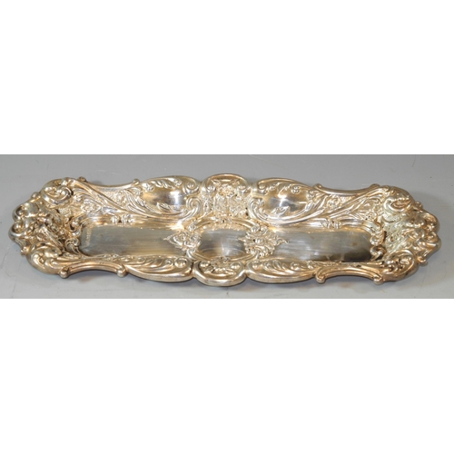 295 - A Victorian style silver pen tray embossed with scrolls  flower heads, horned masks on a matted grou... 