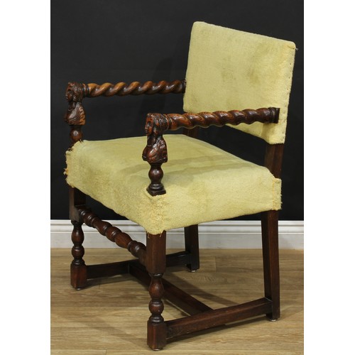 113 - A Jacobean Revival oak open armchair, spirally-turned arms, the arm posts carved as female herms, tu... 