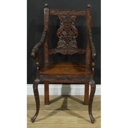 115 - An Anglo-Indian design open armchair, carved throughout with flowers and leaves, cabriole forelegs, ... 