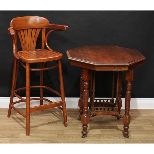 648 - An early 20th century mahogany octagonal centre table; a retro mid 20th century bentwood bar chair (... 