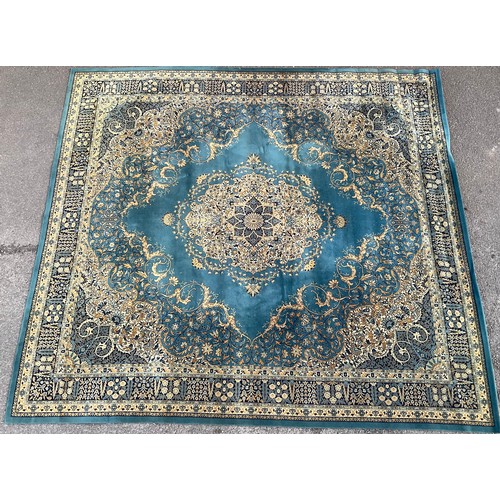 652 - A Persian style woolen carpet, geometric ochre design on blue ground, 406cm long x 364cm wide