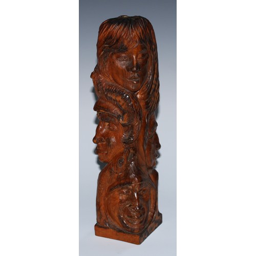 27 - An adzed oak library desk sculpture, as a multi-bust totem pole, carved with heads from varying trad... 