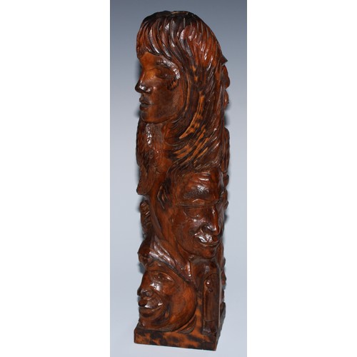 27 - An adzed oak library desk sculpture, as a multi-bust totem pole, carved with heads from varying trad... 