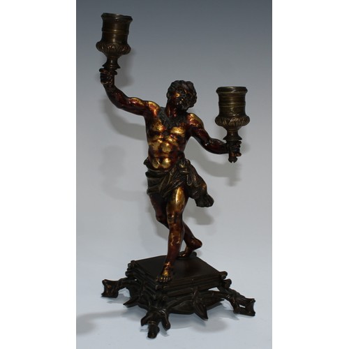 93 - A European gilt and brown patinated bronze figural candelabra, cast as a Mannerist faun, square base... 