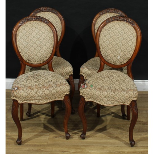 103 - A set of four Victorian walnut dining chairs, stuffed over upholstery, 92cm high, 43.5cm wide, the s... 