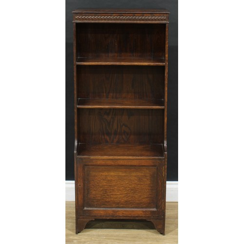 711 - An early 20th century oak bookcase, cupboard to base, 114cm high, 47cm wide, 22cm deep