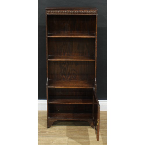 711 - An early 20th century oak bookcase, cupboard to base, 114cm high, 47cm wide, 22cm deep