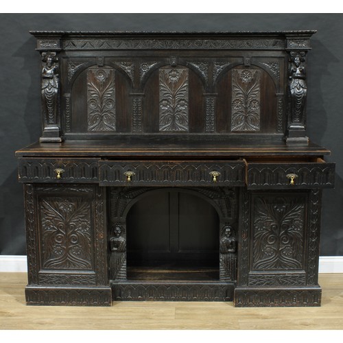 717 - A 17th century style dog kennel sideboard, the back carved and applied with figural pilasters, the b... 