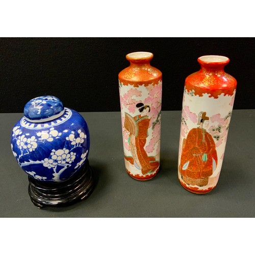 129 - A pair of Japanese Kutani cylindrical vases, decorated in the typical palette with Geisha and man of... 