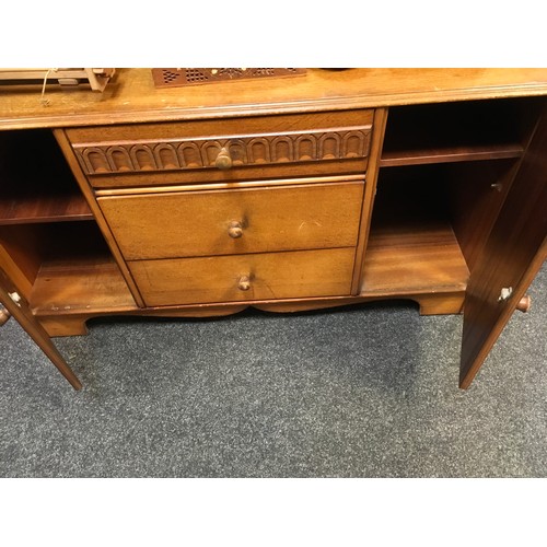 147 - A mid 20th century oak veneered bedroom suite by Austinsuite, comprising two double wardrobes and a ... 