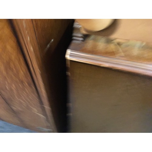 147 - A mid 20th century oak veneered bedroom suite by Austinsuite, comprising two double wardrobes and a ... 