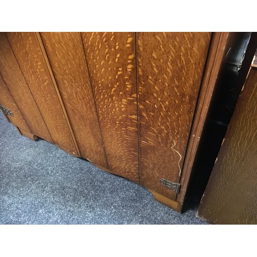 147 - A mid 20th century oak veneered bedroom suite by Austinsuite, comprising two double wardrobes and a ... 