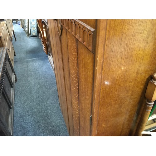 147 - A mid 20th century oak veneered bedroom suite by Austinsuite, comprising two double wardrobes and a ... 