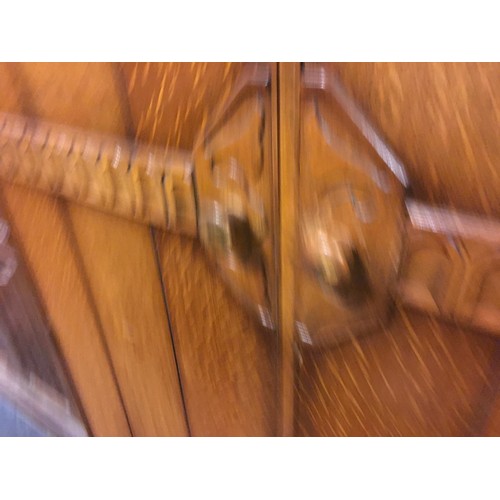 147 - A mid 20th century oak veneered bedroom suite by Austinsuite, comprising two double wardrobes and a ... 