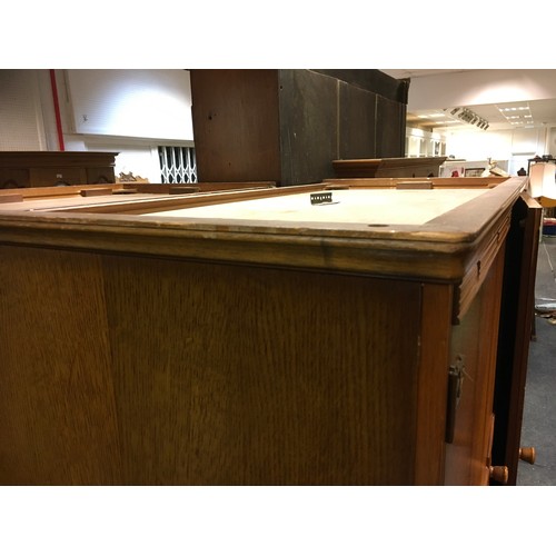 147 - A mid 20th century oak veneered bedroom suite by Austinsuite, comprising two double wardrobes and a ... 