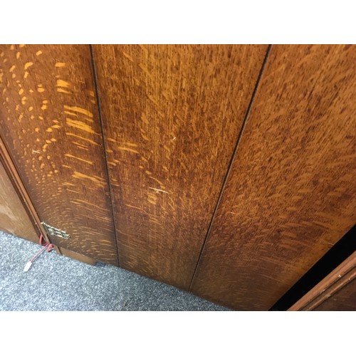 147 - A mid 20th century oak veneered bedroom suite by Austinsuite, comprising two double wardrobes and a ... 