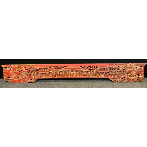 148 - A large carved and pierced Chinese gilt red wooden panel, decorated with many figures, Phoenix and t... 