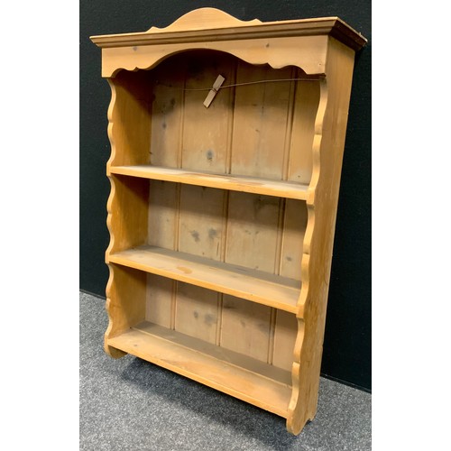 151 - A pine wall hanging shelf, shaped cornice, 77cm high, 54cm wide