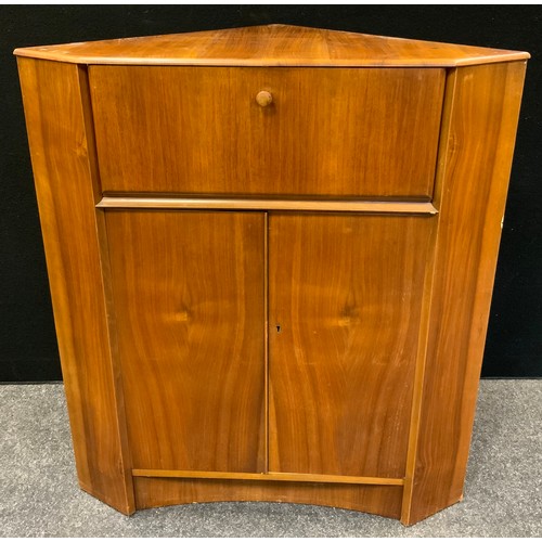 159 - A retro mid-20th century Nathan corner bureau, fall front enclosing pigeon holes, above a pair of do... 