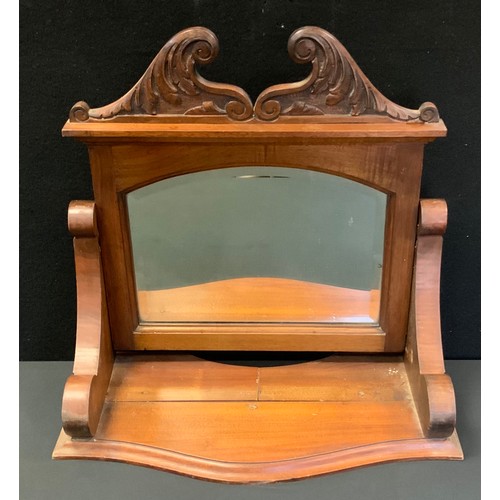 144 - A Victorian dressing table mirror, carved crest and supports, serpentine front, arched bevelled plat... 