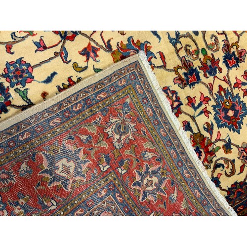 72 - A fine Kashan rug / carpet, woven in shades of red, cream, and blue, 310cm x 205cm.