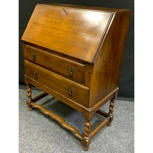 74 - A 20th century oak bureau, fall-front above two long drawers, barley twist support, 100cm high, 73cm... 