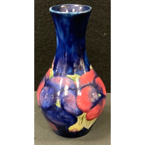 107 - A Moorcroft Pansy pattern ovoid vase, tube lined with large flowerheads, on a blue ground, 14.5cm hi... 