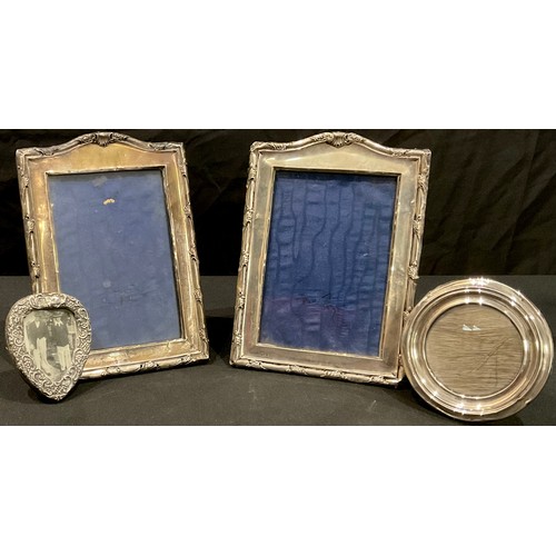 96 - A pair of hallmarked silver photograph frames; others, circular and heart shaped (4)