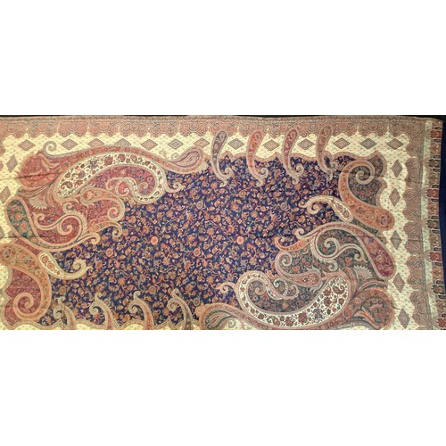 99 - Textiles - a silk and wool Paisley shawl, in shades of red, green and orange on a cobalt blue ground... 