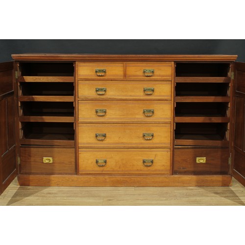 5 - A late Victorian/Edwardian low press cupboard, slightly oversailing top above two short and four lon... 