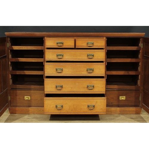 5 - A late Victorian/Edwardian low press cupboard, slightly oversailing top above two short and four lon... 