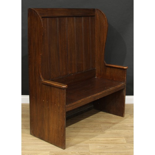 13 - An oak double-width lambing chair or wingback settle, 137.5cm high, 120.5cm wide, 53cm deep, the sea... 