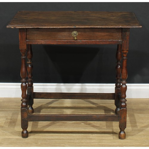 16 - An 18th century design oak side table, oversailing top above a long frieze drawer, turned supports, ... 