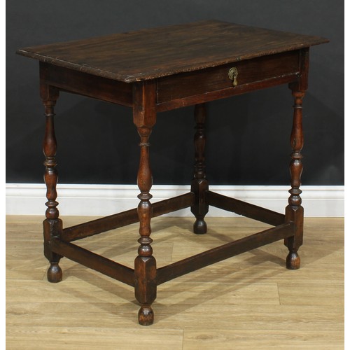 16 - An 18th century design oak side table, oversailing top above a long frieze drawer, turned supports, ... 