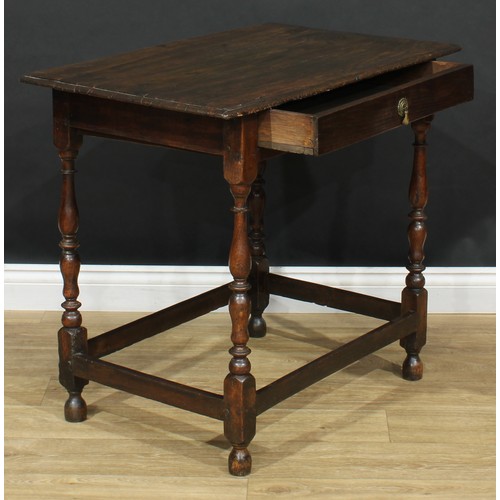 16 - An 18th century design oak side table, oversailing top above a long frieze drawer, turned supports, ... 