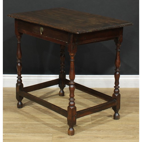 16 - An 18th century design oak side table, oversailing top above a long frieze drawer, turned supports, ... 