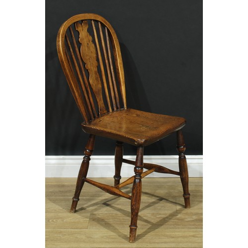 17 - A pair of 19th century Windsor-form side chairs, each with a hoop back, shaped splat, saddle seat, t... 
