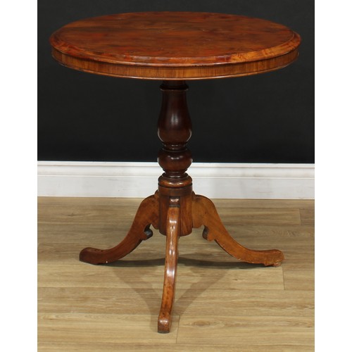 18 - A 19th century vernacular tripod centre table, possibly Welsh, circular yew top, turned column, cabr... 