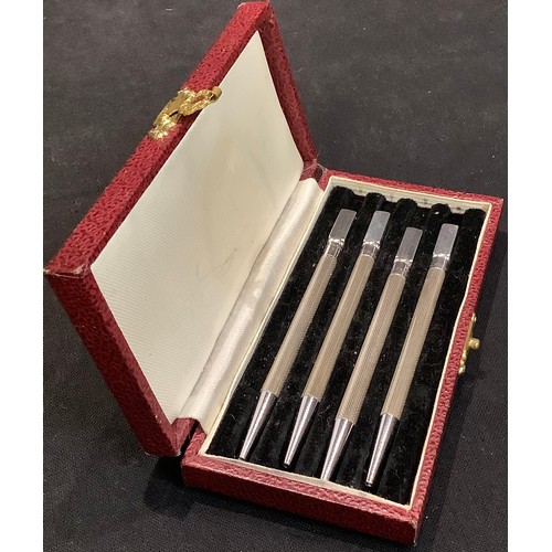 73 - A set of four silver propelling pencils, marked Sterling Silver, cased