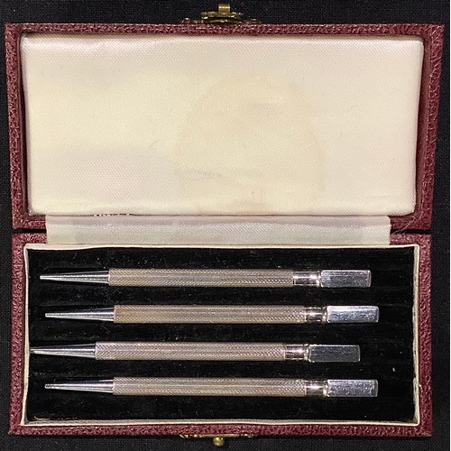 73 - A set of four silver propelling pencils, marked Sterling Silver, cased