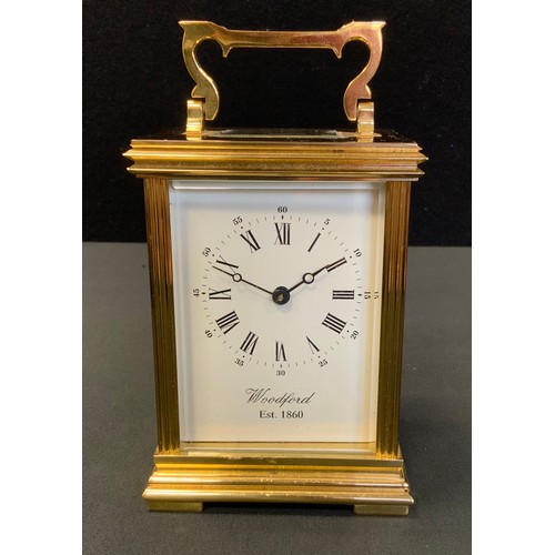 7 - A brass carriage timepiece, Roman numerals, bevelled glass, the dial marked Woodford Est 1860