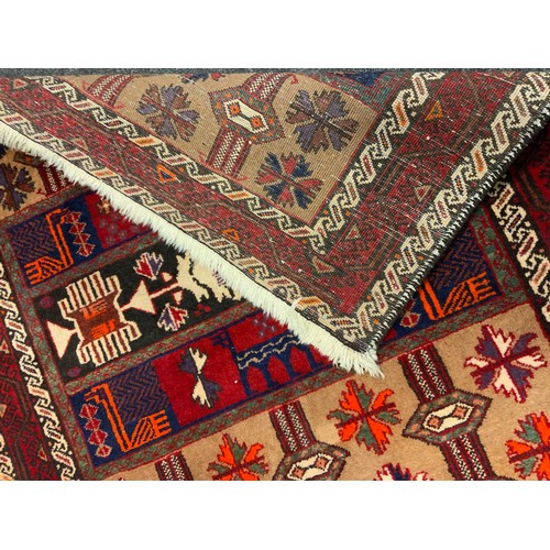 27 - A hand-knotted Persian Balouch (Baluch) rug / carpet, woven with stylised geometric motifs in shades... 