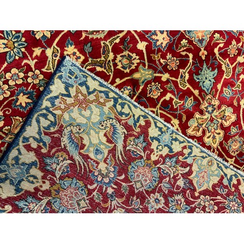 50 - A Persian 'Ishfahan' rug / carpet, knotted in tones of pale blue, cream, and red, central lotus form... 