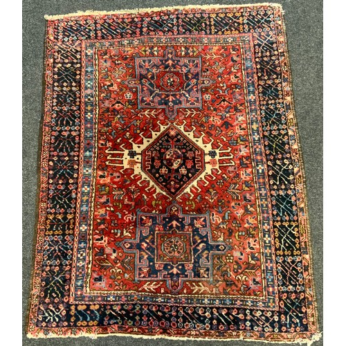 58 - An Antique, hand-knotted, Persian Heriz rug / carpet, with stylised motifs in shades of pale blue, d... 