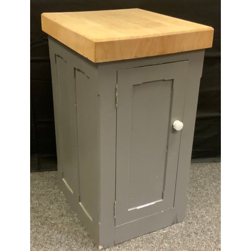 62 - A Beechwood butchers block on reclaimed pine stand, rectangular top above a cupboard door enclosing ... 